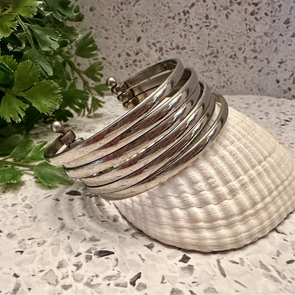 Silver tone metal open bangle bracelet